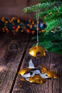 65402424-broken-old-vintage-christmas-ball-on-wooden-table-christmas-lights-and-christmas-tree-
